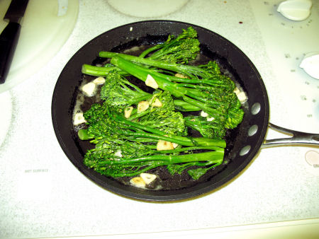 Broccolini sauteeing in butter & garlic
